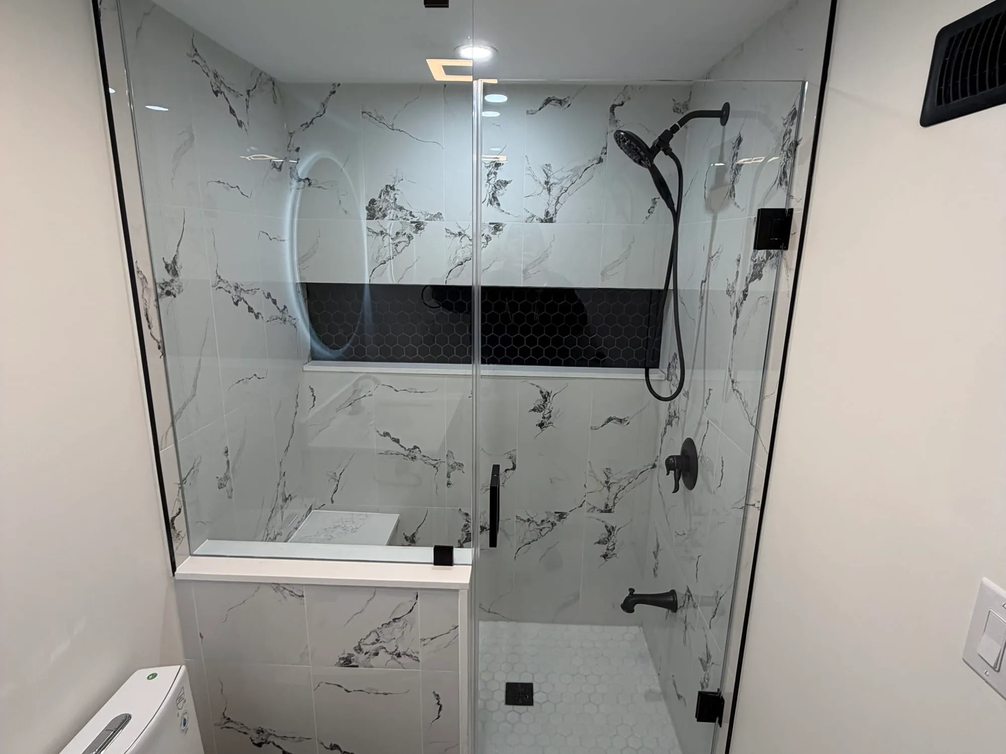 Finished lower-level bathroom and laundry — Northpole Design & Build