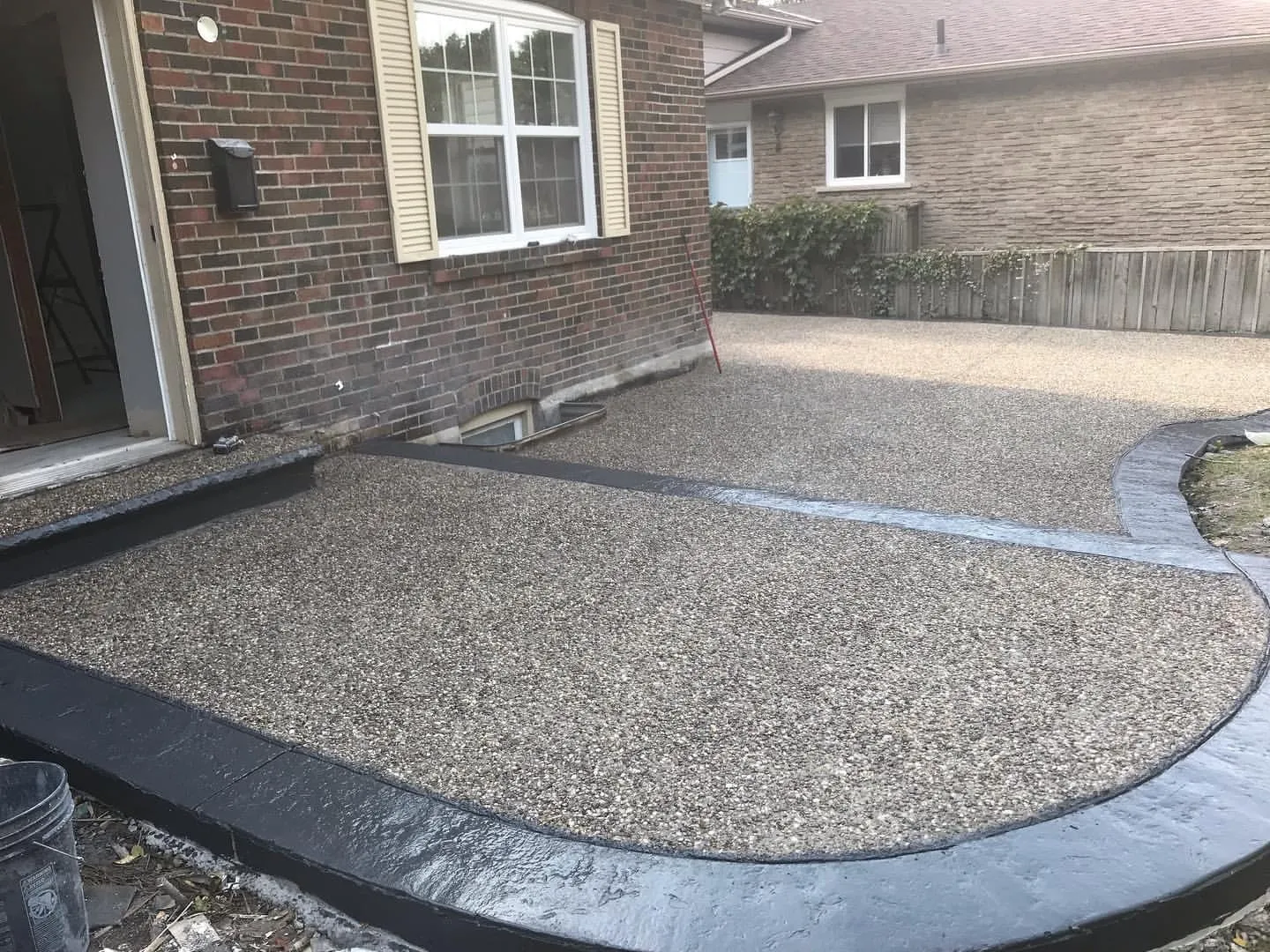 Exposed-aggregate concrete driveway — Northpole Design & Build